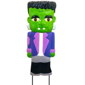 Inflatable Frankenstein monster Halloween decoration with a green face, black hair, purple jacket, gray pants, on a stand.